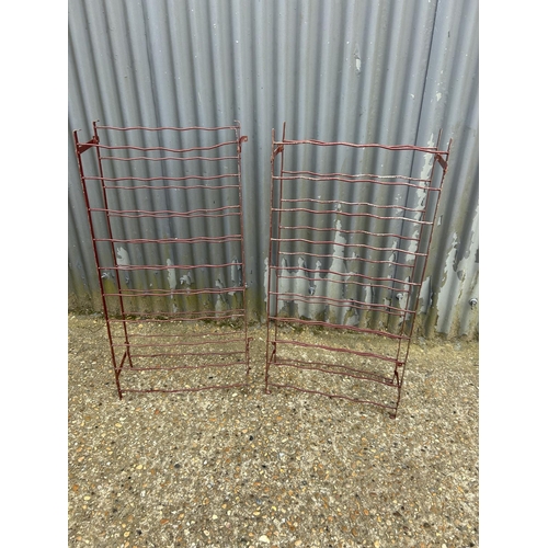 146 - A pair of red metalwork folding wine racks