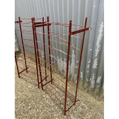 146 - A pair of red metalwork folding wine racks