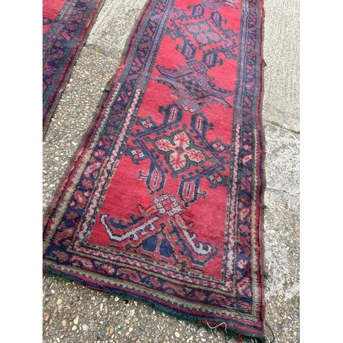 149 - A pair of red and blue oriental runner rugs 360x 95