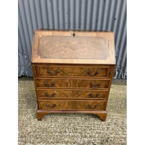 159 - A reproduction walnut bureau