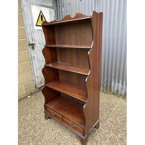 165 - A mahogany waterfall front bookcase  with drawer 77x40x150