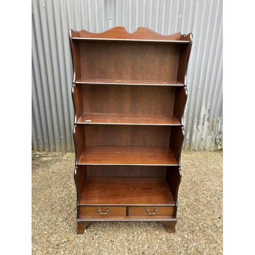 165 - A mahogany waterfall front bookcase  with drawer 77x40x150