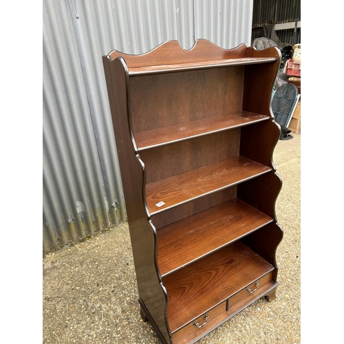 165 - A mahogany waterfall front bookcase  with drawer 77x40x150