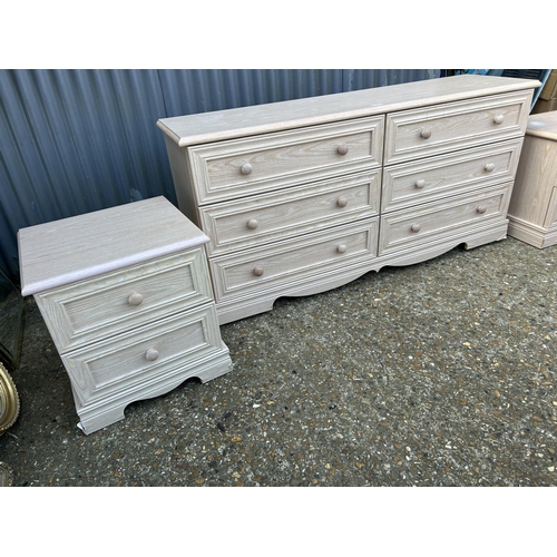 182 - A modern light oak effect lowboy chest of six drawers together with a pair of matching bedsides larg... 