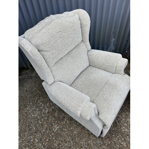 183 - A clean pair of beige upholstered armchairs (one recliner)