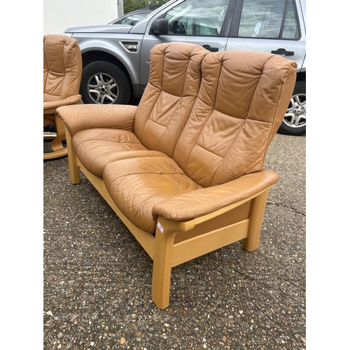 2 - A  tan brown leather EKORNES STRESSLESS two seater sofa together with matching reclining armchair