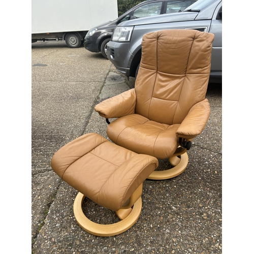 2 - A  tan brown leather EKORNES STRESSLESS two seater sofa together with matching reclining armchair