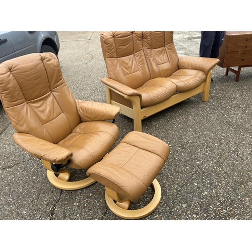 2 - A  tan brown leather EKORNES STRESSLESS two seater sofa together with matching reclining armchair