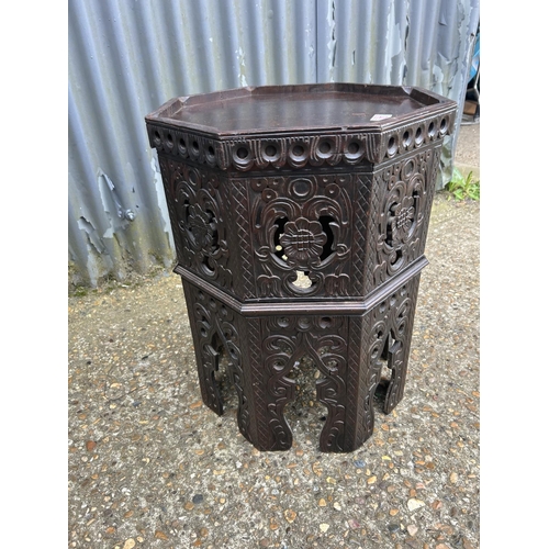 201 - A carved octagonal table 40 diameter 65 cm high