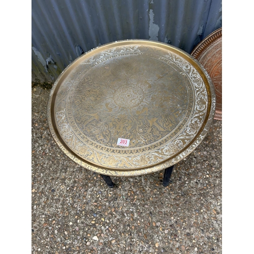 203 - A brass tray top table on folding base together with an additional copper tray