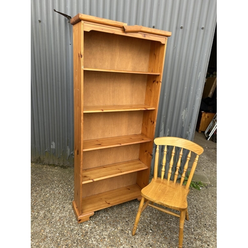 209 - A tall pine bookcase and a pine chair