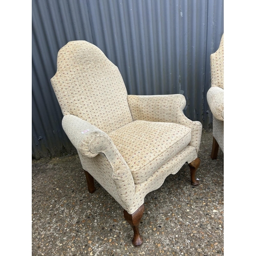 213 - A pair of gold pattern armchairs