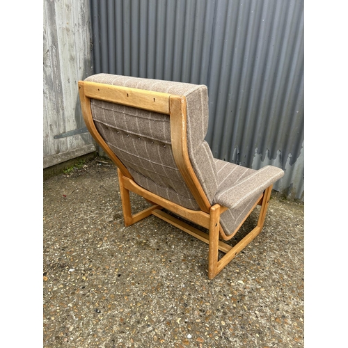 221 - A mid centuey teak framed lounge chair with brown stripe upholstery