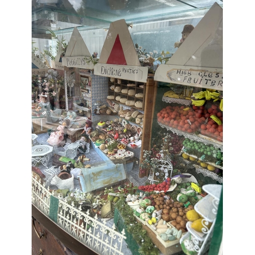 226 - An aquarium tank now converted to house a miniature market scene with dolls and furnishings 122x44x ... 