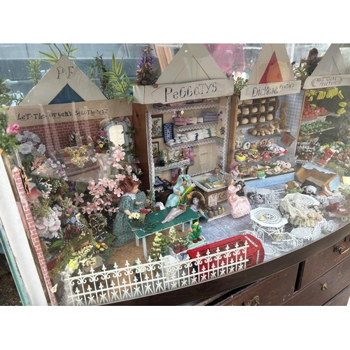 226 - An aquarium tank now converted to house a miniature market scene with dolls and furnishings 122x44x ... 