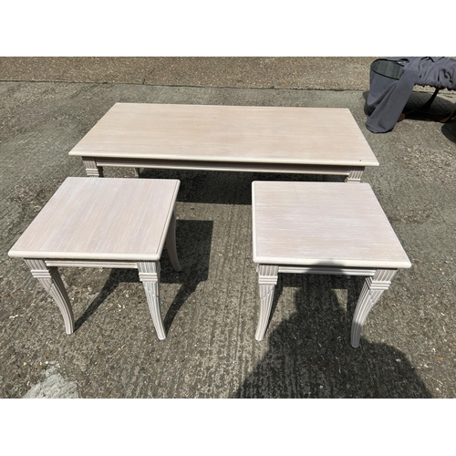 229 - A large limed ash coffee table 136x66 together with two smaller matching occasional tables