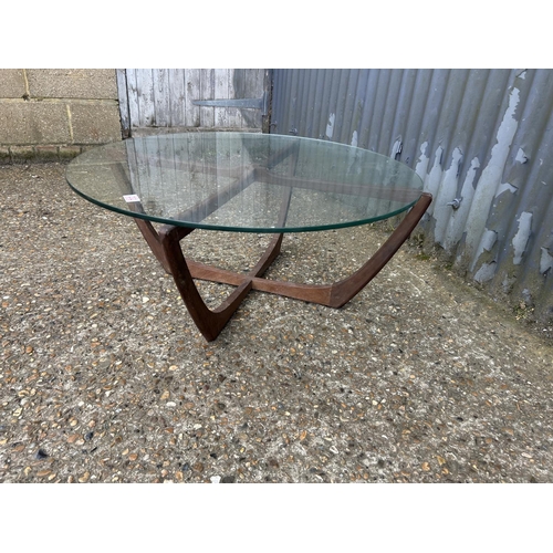 232 - A g plan teak framed spider coffee table 86cm diameter with thick glass top