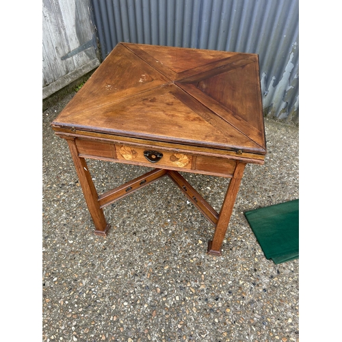 239 - An arts and crafts oak envelope card table with folding top and single drawer, 76x76x77