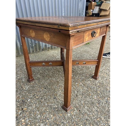 239 - An arts and crafts oak envelope card table with folding top and single drawer, 76x76x77