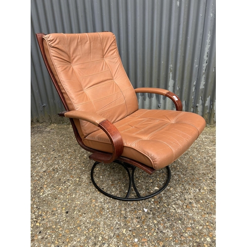 241 - A mid century style tan brown leather and rosewood effect swivel chair