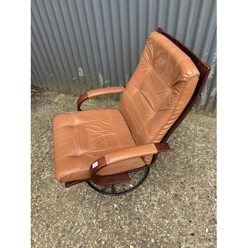 241 - A mid century style tan brown leather and rosewood effect swivel chair