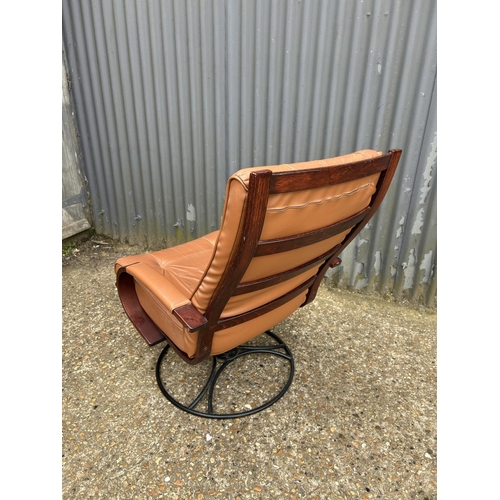 241 - A mid century style tan brown leather and rosewood effect swivel chair