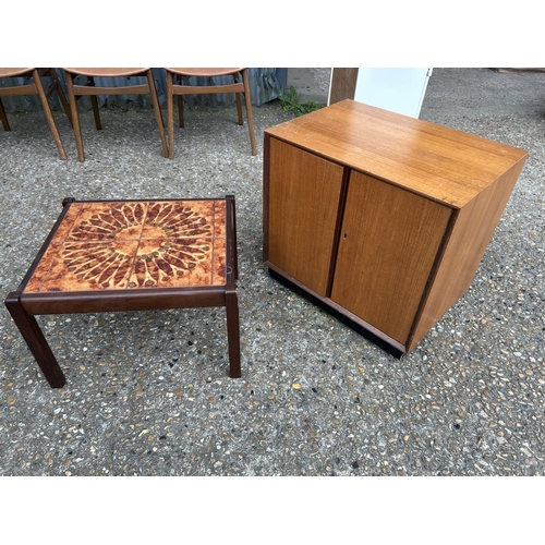 247 - A mid centuey teak record cupboard together with a small tile top coffee table