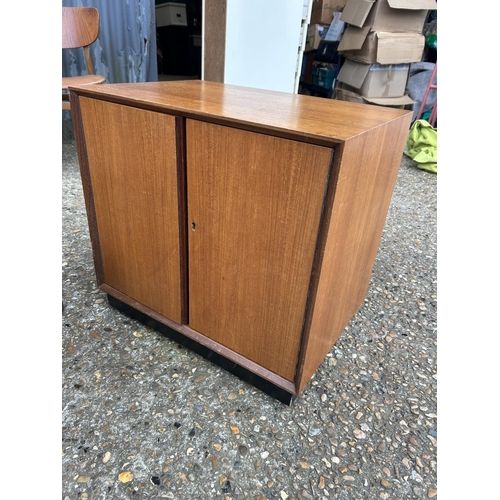 247 - A mid centuey teak record cupboard together with a small tile top coffee table