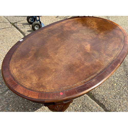 252 - A mahogany Oval Office writing table with brown leather top  168x108