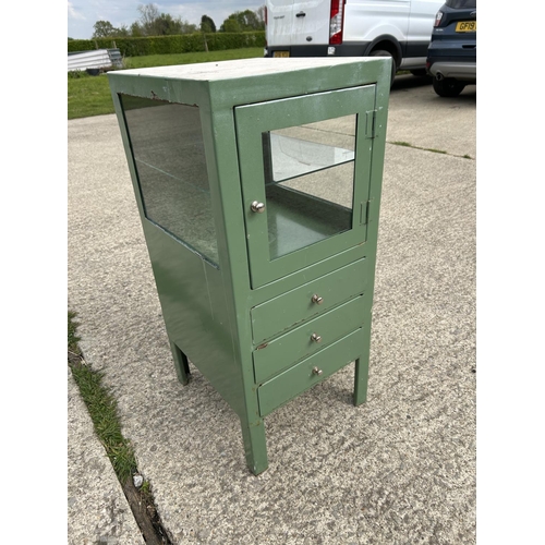 264 - A green painted metal medical cabinet with glazed top over three drawers 40x45x90