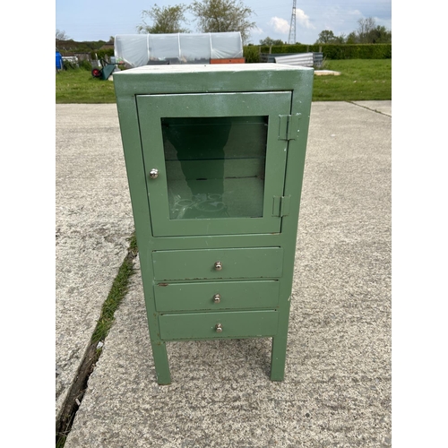 264 - A green painted metal medical cabinet with glazed top over three drawers 40x45x90