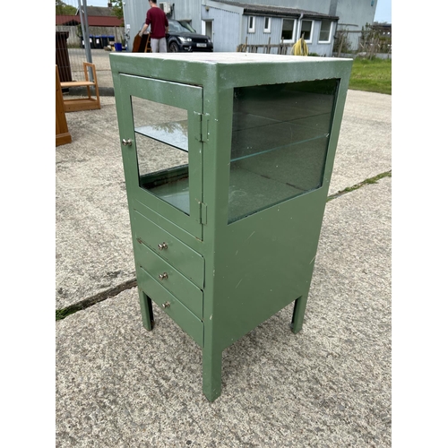 264 - A green painted metal medical cabinet with glazed top over three drawers 40x45x90