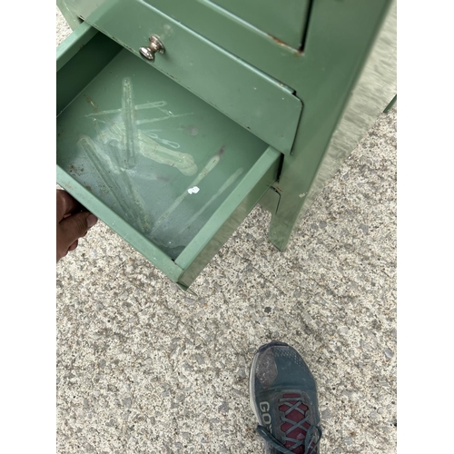 264 - A green painted metal medical cabinet with glazed top over three drawers 40x45x90