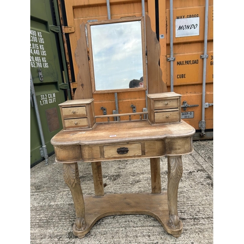 269 - A stripped pine dressing table with swing mirror