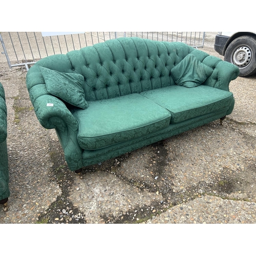 27 - A pair of green pattern oyster shell shaped sofas