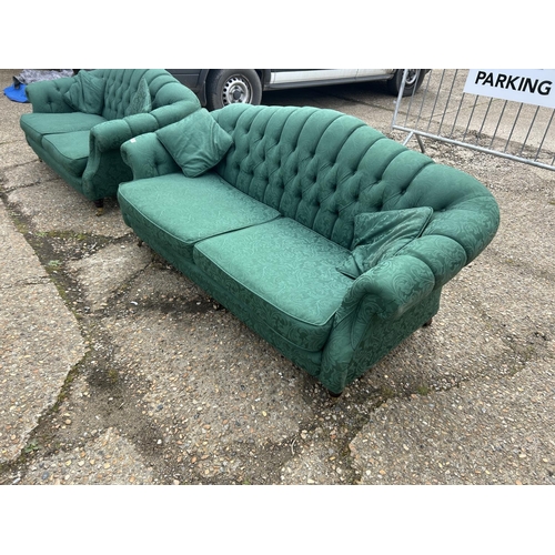 27 - A pair of green pattern oyster shell shaped sofas