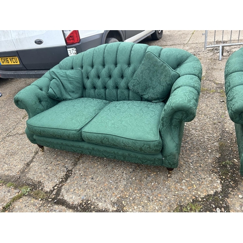 27 - A pair of green pattern oyster shell shaped sofas