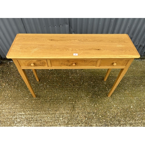 3 - A light oak three drawer table 116x85x77