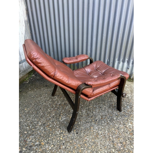 43 - A mid century dark red leather reclining easy chair