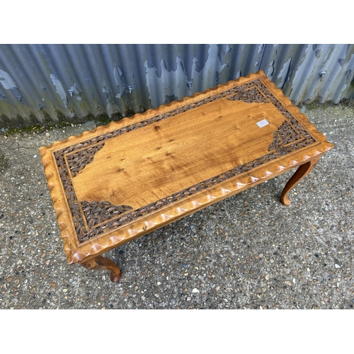 53 - A carved hardwood coffee table