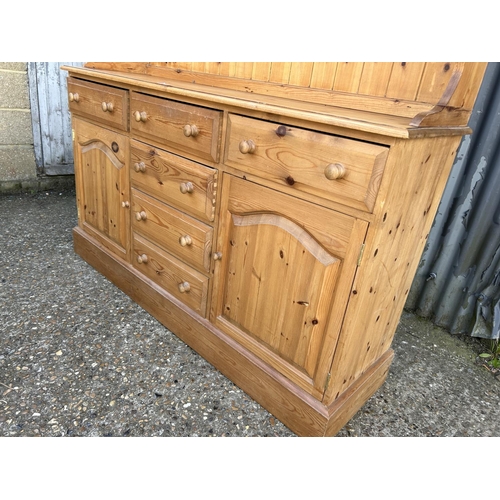 66 - A country pine dresser with glazed top over six drawer and two door base 154x44x200