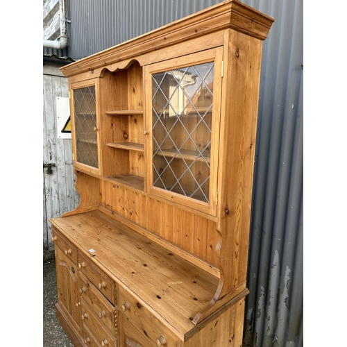 66 - A country pine dresser with glazed top over six drawer and two door base 154x44x200