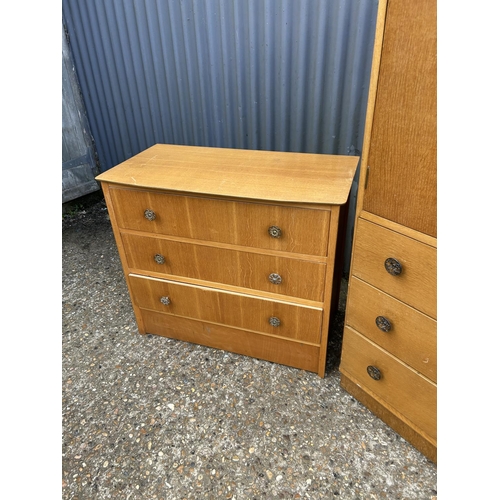 74 - A mid century light oak bedroom pair consisting of a tallboy and matching chest of four