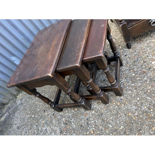 79 - An oak nest of three tables together with a single drawer side table