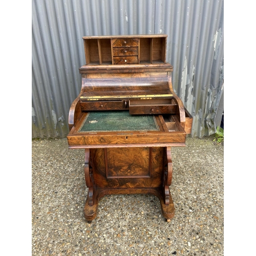 91 - A Victorian walnut davenport with pop up up top, sliding writing surface and fitted interior