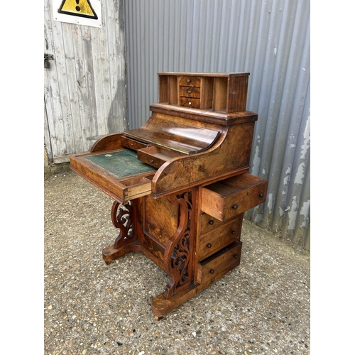 91 - A Victorian walnut davenport with pop up up top, sliding writing surface and fitted interior