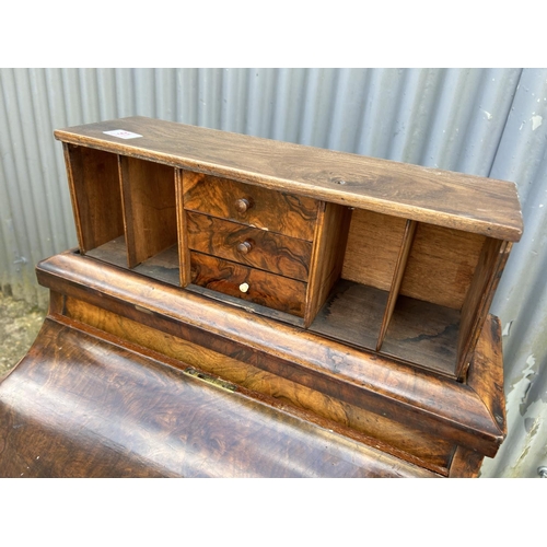 91 - A Victorian walnut davenport with pop up up top, sliding writing surface and fitted interior