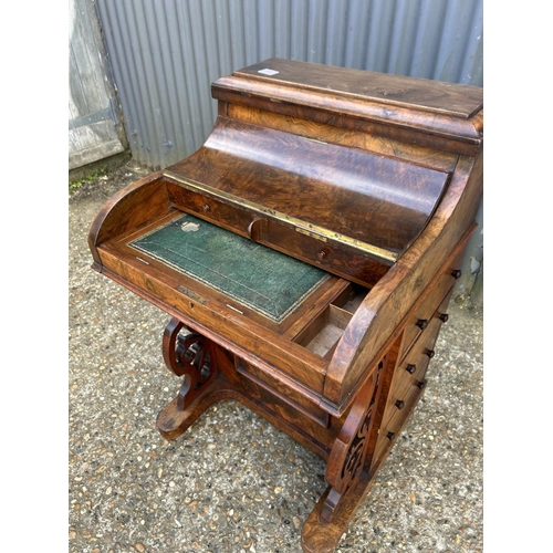 91 - A Victorian walnut davenport with pop up up top, sliding writing surface and fitted interior