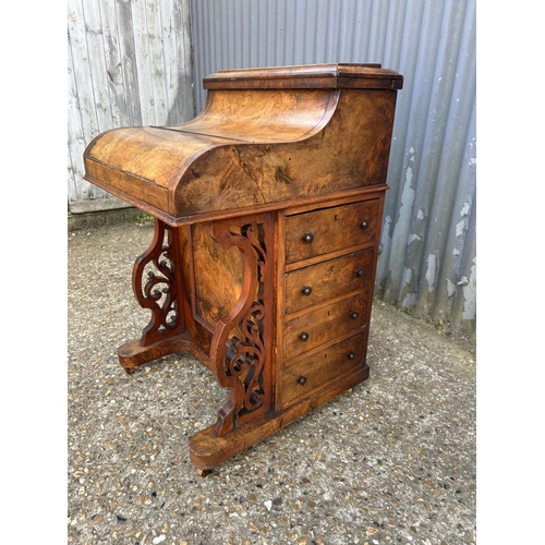 91 - A Victorian walnut davenport with pop up up top, sliding writing surface and fitted interior