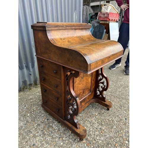 91 - A Victorian walnut davenport with pop up up top, sliding writing surface and fitted interior